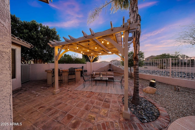 25454 N 73rd Ave, Peoria, AZ 85383 - patio terrace at dusk featuring an outdoor hangout area, outdoor dry bar, a fenced backyard, and a pergola