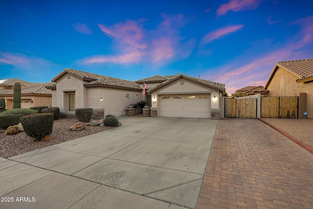 25454 N 73rd Ave, Peoria, AZ 85383 - mediterranean / spanish home featuring stucco siding, a gate, a tiled roof, and concrete driveway