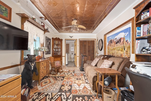 miscellaneous room with a raised ceiling, ornamental molding, and ceiling fan