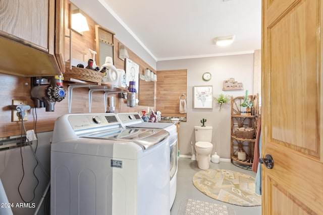 laundry area with light tile flooring, ornamental molding, and separate washer and dryer