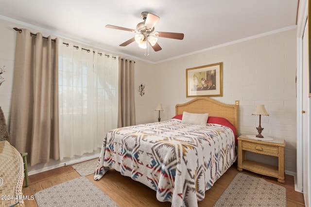 bedroom with light hardwood / wood-style flooring, ornamental molding, and ceiling fan