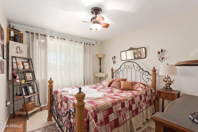 tiled bedroom featuring ceiling fan