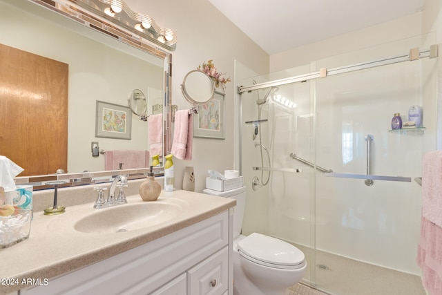 bathroom featuring an enclosed shower, toilet, and vanity with extensive cabinet space