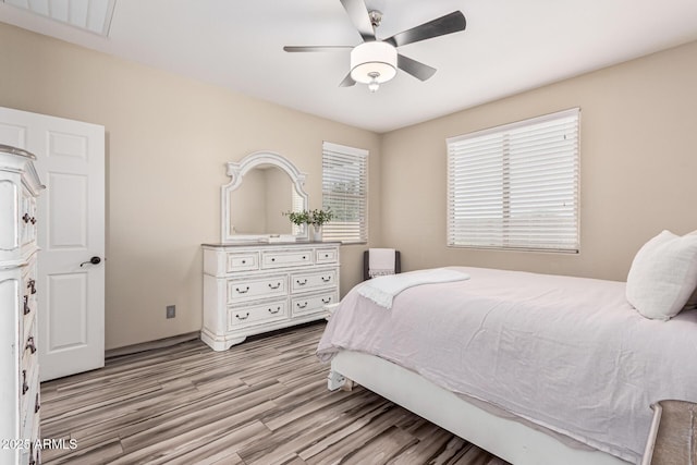 bedroom with ceiling fan and wood finished floors