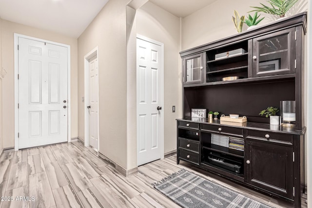 interior space with light wood-style flooring and baseboards