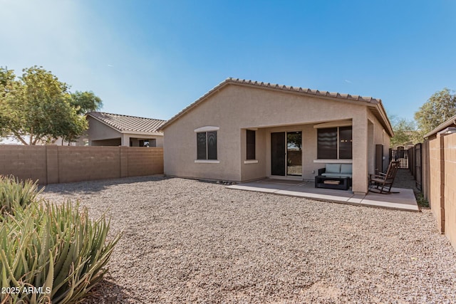 rear view of house featuring a patio, a fenced backyard, and stucco siding