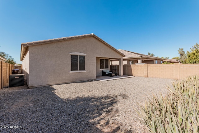 back of property featuring a fenced backyard, stucco siding, cooling unit, and a patio