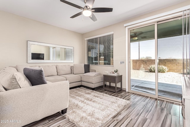 living room with a ceiling fan and wood finished floors