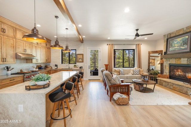 2582 S Cottonrose Ln, Flagstaff, AZ 86001 - living room featuring recessed lighting, light wood finished floors, a ceiling fan, beam ceiling, and a fireplace