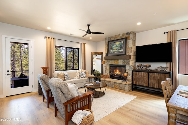 2582 S Cottonrose Ln, Flagstaff, AZ 86001 - living room featuring light wood-style flooring, a fireplace, ceiling fan, recessed lighting, and baseboards