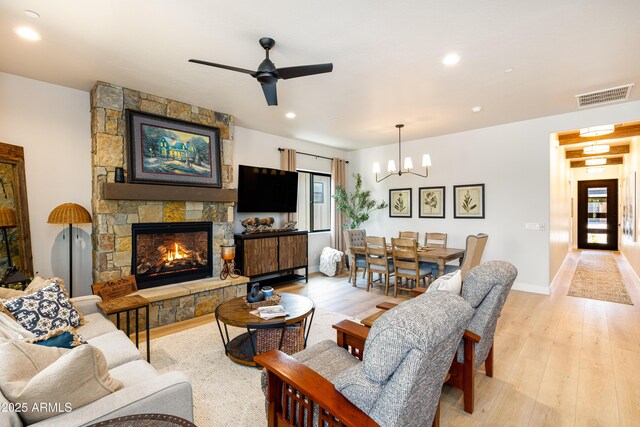 2582 S Cottonrose Ln, Flagstaff, AZ 86001 - living area with a chandelier, ceiling fan, light wood finished floors, recessed lighting, and a fireplace