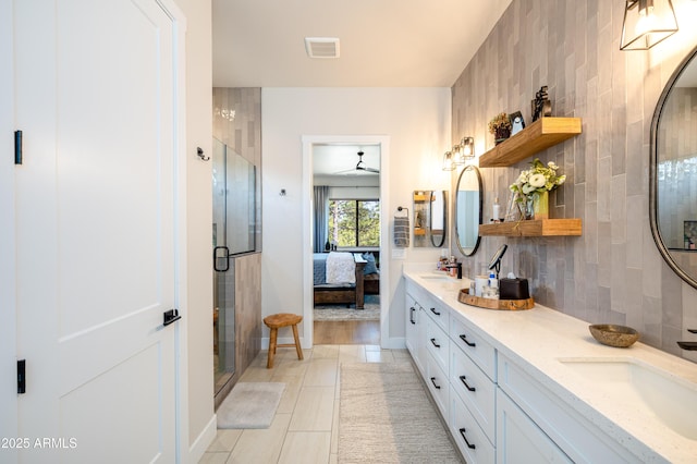 2582 S Cottonrose Ln, Flagstaff, AZ 86001 - ensuite bathroom with double vanity, tile patterned floors, a shower stall, baseboards, and a ceiling fan