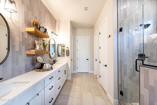 2582 S Cottonrose Ln, Flagstaff, AZ 86001 - bathroom with a shower stall, double vanity, decorative backsplash, and baseboards
