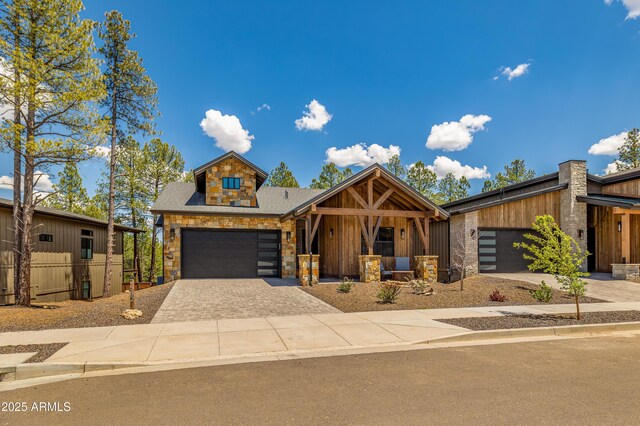 2582 S Cottonrose Ln, Flagstaff, AZ 86001 - view of front of house with decorative driveway, stone siding, covered porch, and a shingled roof