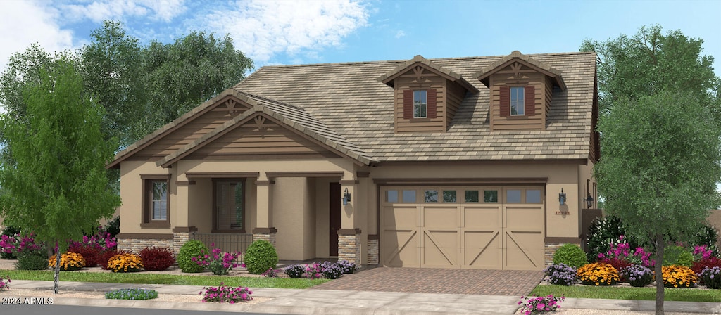 view of front of home featuring a porch and a garage