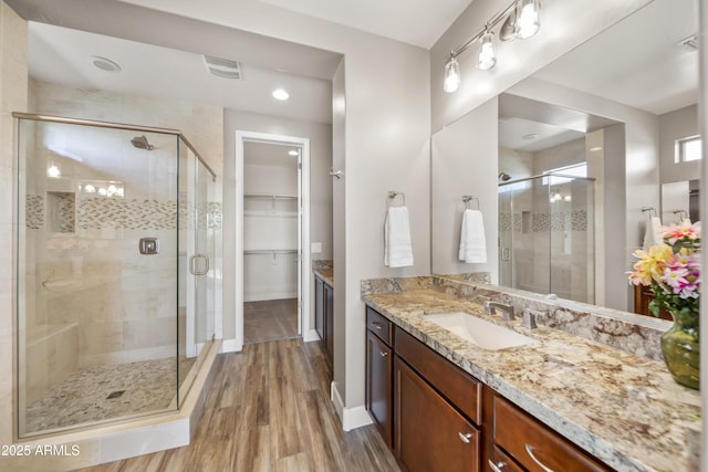 bathroom featuring vanity, hardwood / wood-style floors, and an enclosed shower