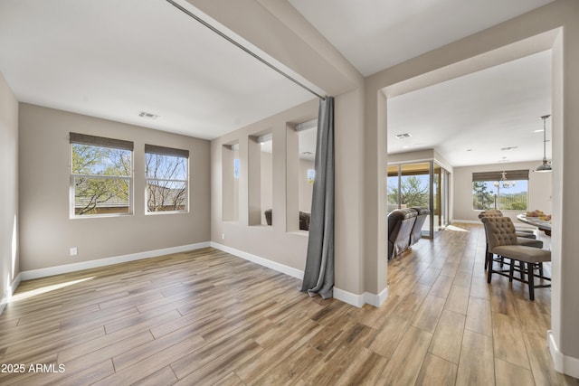 interior space featuring light hardwood / wood-style flooring and a notable chandelier