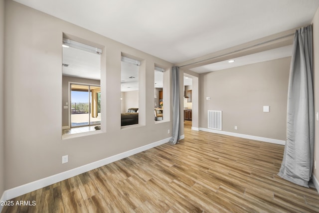 unfurnished room featuring hardwood / wood-style flooring