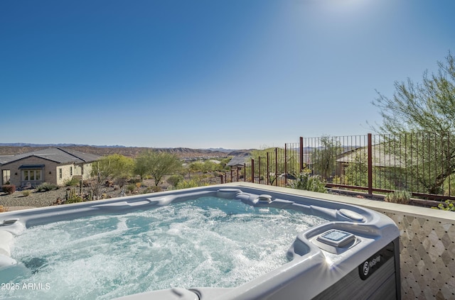 view of swimming pool featuring a hot tub