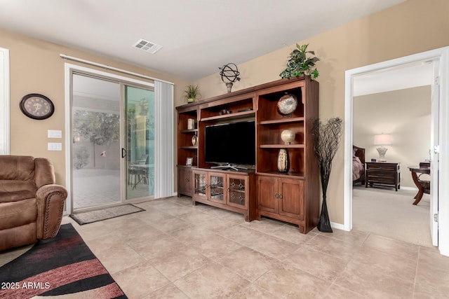 living room featuring light tile patterned flooring and visible vents