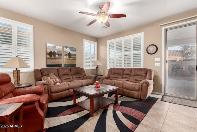living area with light tile patterned flooring and ceiling fan