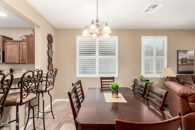dining room with baseboards, visible vents, a notable chandelier, and light tile patterned floors