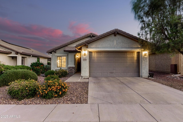 ranch-style house featuring stucco siding, a tile roof, driveway, and a garage