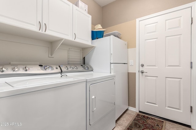 washroom featuring separate washer and dryer and cabinet space