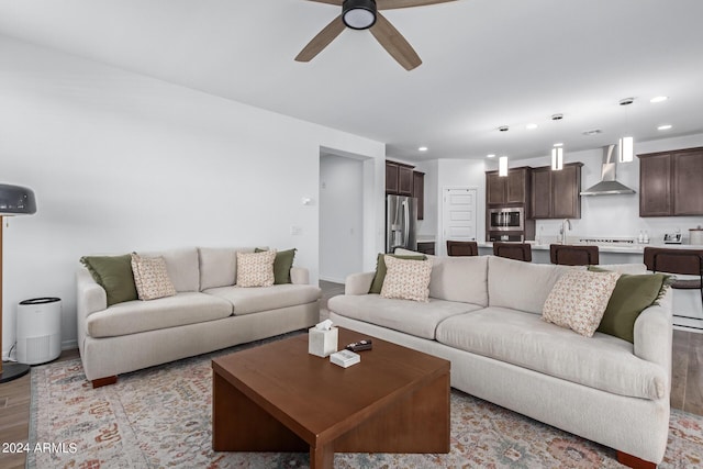 living room featuring light hardwood / wood-style floors and ceiling fan