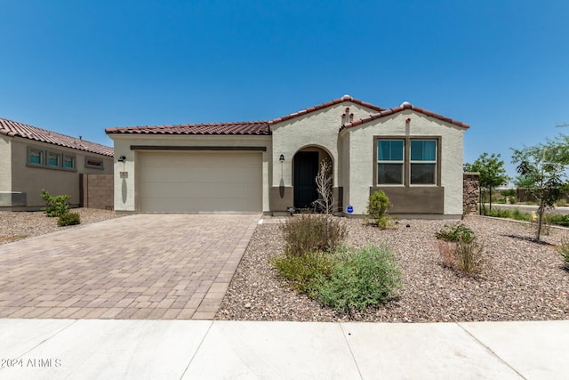 mediterranean / spanish-style house with a garage