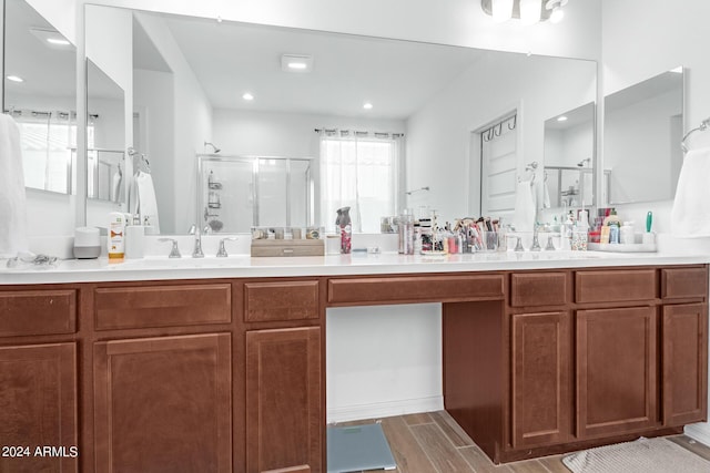 bathroom featuring vanity and an enclosed shower