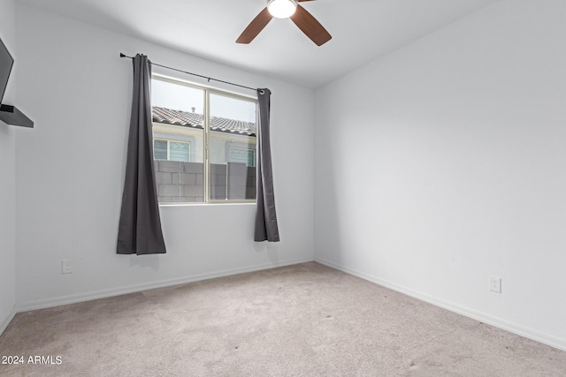 unfurnished room featuring ceiling fan and light carpet