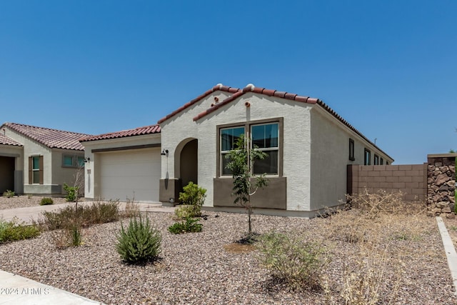 mediterranean / spanish-style house featuring a garage