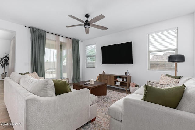 living room featuring light hardwood / wood-style floors and ceiling fan