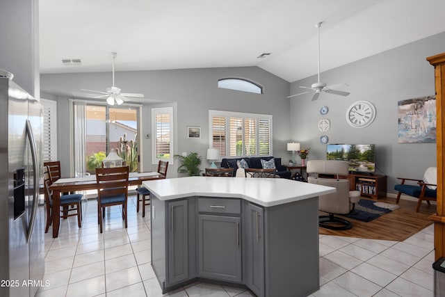 17611 W Ingleside Dr, Surprise, AZ 85374 - kitchen with vaulted ceiling, a ceiling fan, stainless steel fridge, and gray cabinets