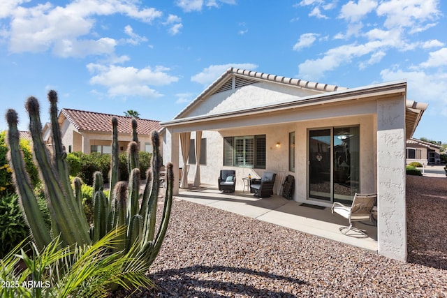 17611 W Ingleside Dr, Surprise, AZ 85374 - back of house featuring stucco siding, a tiled roof, and a patio area
