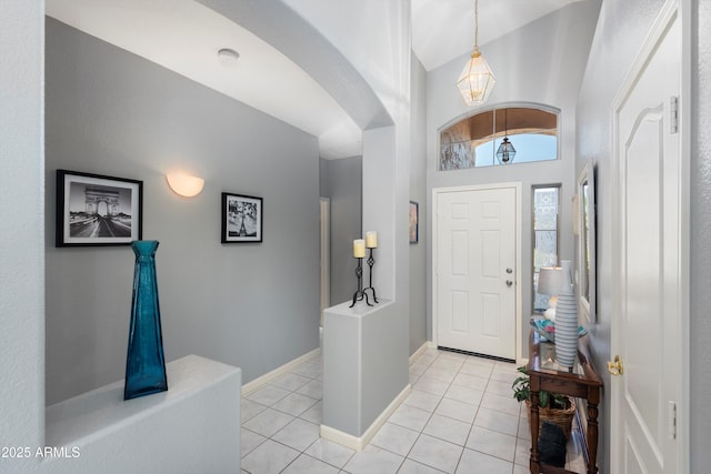 17611 W Ingleside Dr, Surprise, AZ 85374 - entryway with light tile patterned floors, baseboards, a notable chandelier, and arched walkways