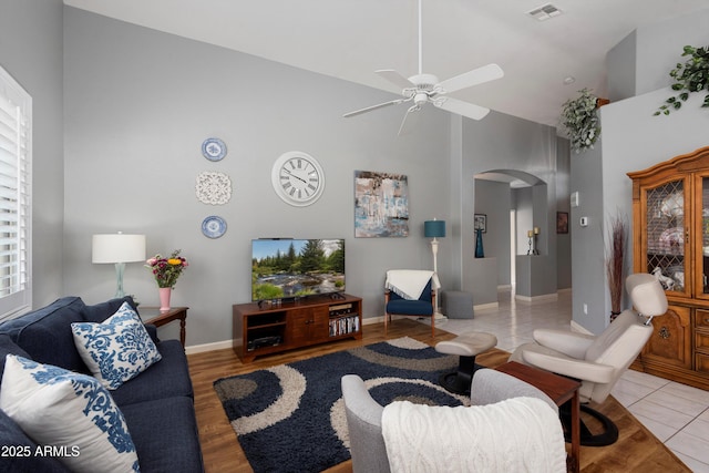 17611 W Ingleside Dr, Surprise, AZ 85374 - living area with visible vents, baseboards, arched walkways, a ceiling fan, and high vaulted ceiling