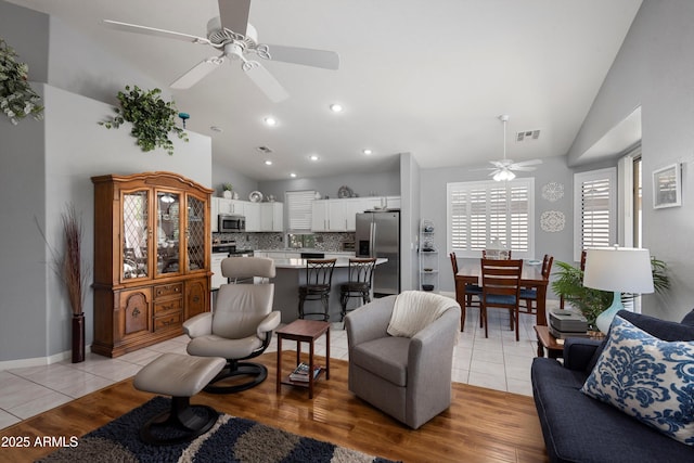 17611 W Ingleside Dr, Surprise, AZ 85374 - living area with lofted ceiling, light tile patterned flooring, ceiling fan, and recessed lighting