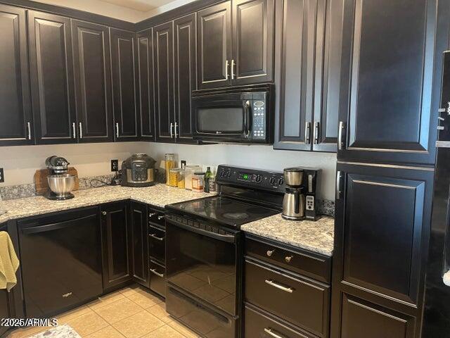 22744 E Carla Vista Dr, Mesa, AZ 85212 - kitchen with black appliances, light tile patterned floors, and light stone counters