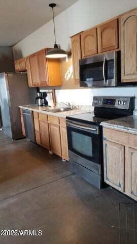 22744 E Carla Vista Dr, Mesa, AZ 85212 - kitchen featuring a sink, concrete floors, stainless steel appliances, light countertops, and hanging light fixtures