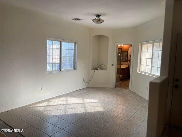 22744 E Carla Vista Dr, Mesa, AZ 85212 - unfurnished room featuring visible vents, baseboards, and arched walkways