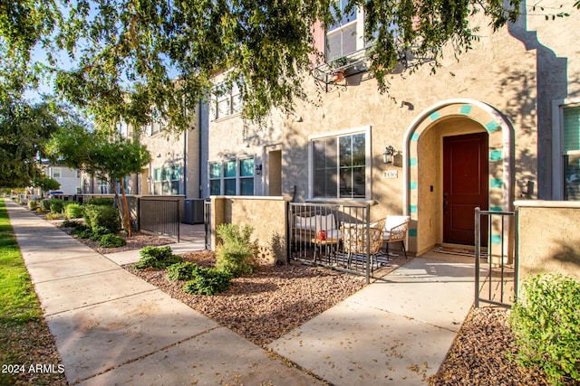 view of exterior entry featuring central AC unit