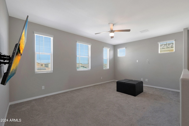 interior space with light carpet and ceiling fan