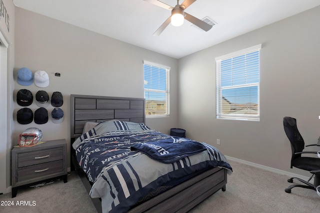 carpeted bedroom with multiple windows and ceiling fan