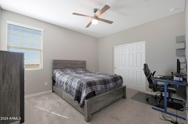 carpeted bedroom with ceiling fan and a closet