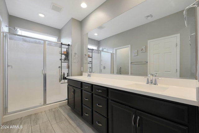 bathroom featuring vanity and an enclosed shower