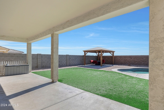 view of yard with a fenced in pool, a gazebo, and a patio area