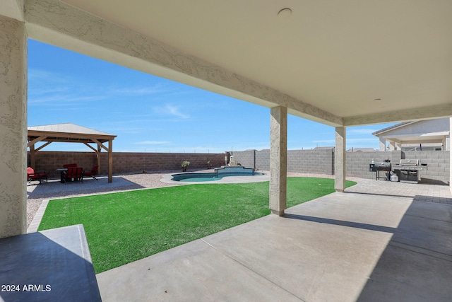 view of patio / terrace featuring a gazebo, a swimming pool with hot tub, and a grill