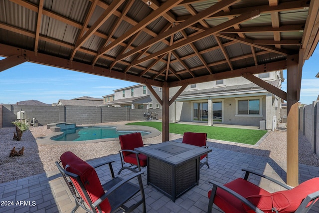 view of patio / terrace featuring a fenced in pool and a gazebo